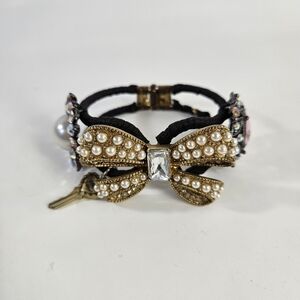 Betsey Johnson Black and Gold Bracelet with Intricate Detailing